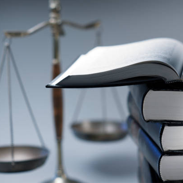 Image of a balance scale and stack of legal books