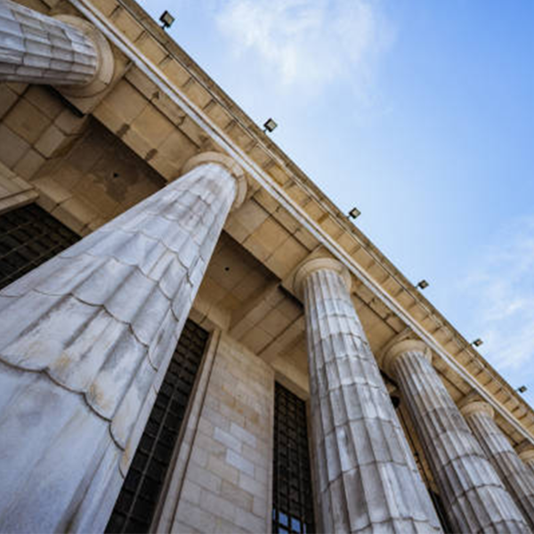 Low angle photo of courthouse columns rising up