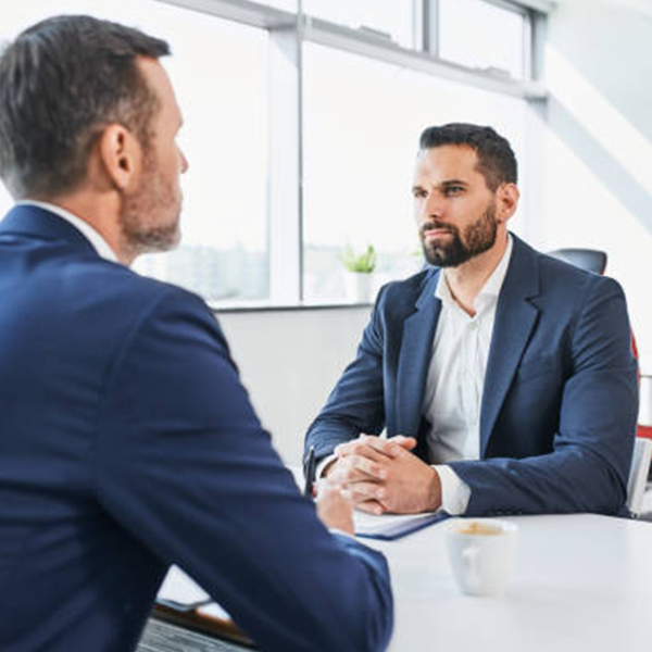 Two professionals speaking to each other.