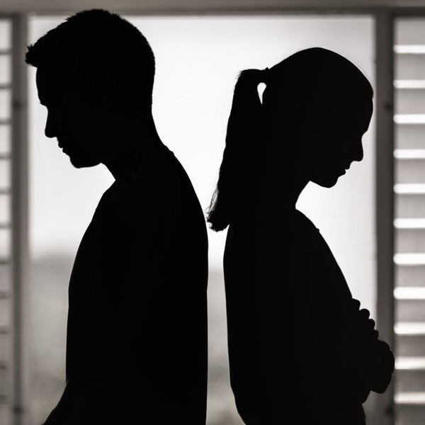 Silhouette of couple back-to-back