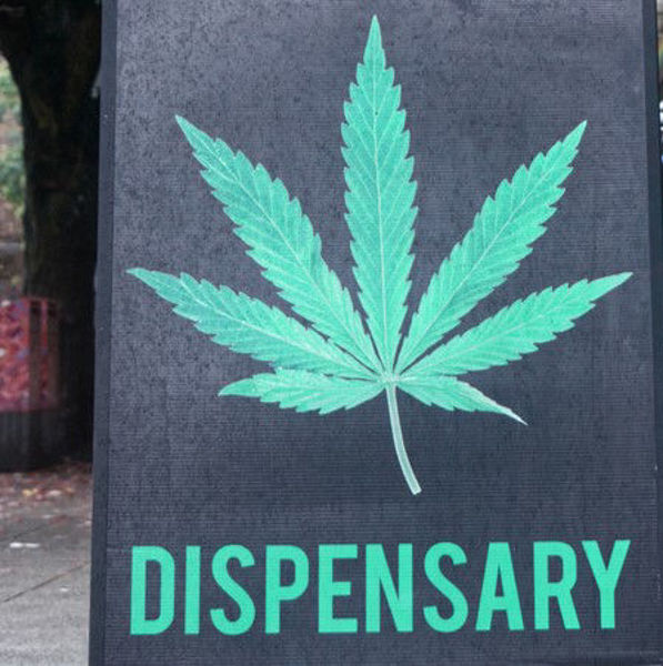 Black sign reading Dispensary.