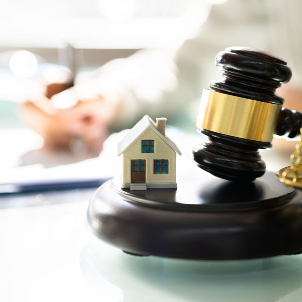 Gavel next to small model house