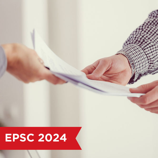 Close up of two people exchanging a document