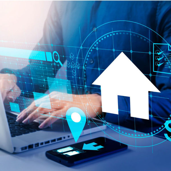 Photo of person working at a laptop with overlay of house and other graphics