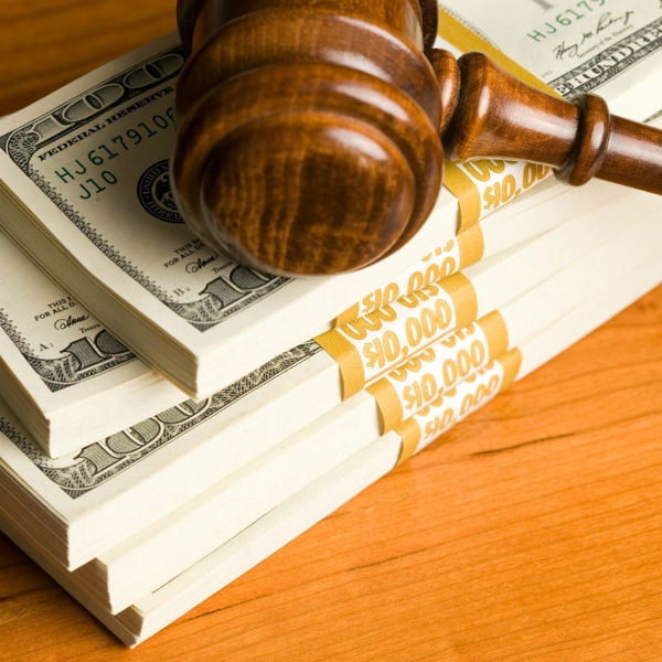 Gavel resting on a stack of bundles of U.S. currency