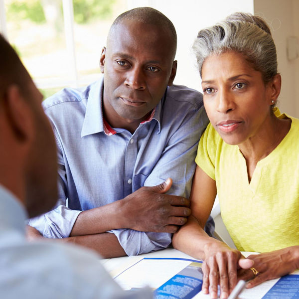 Couple listening to advice from attorney