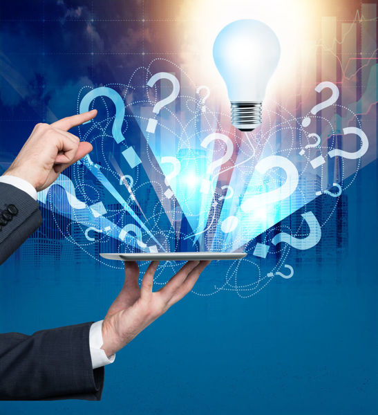 Man holding a laptop with question marks and a lightbulb emerging from it