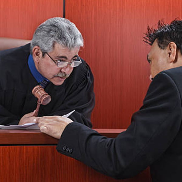 Attorney and judge speaking at the bench